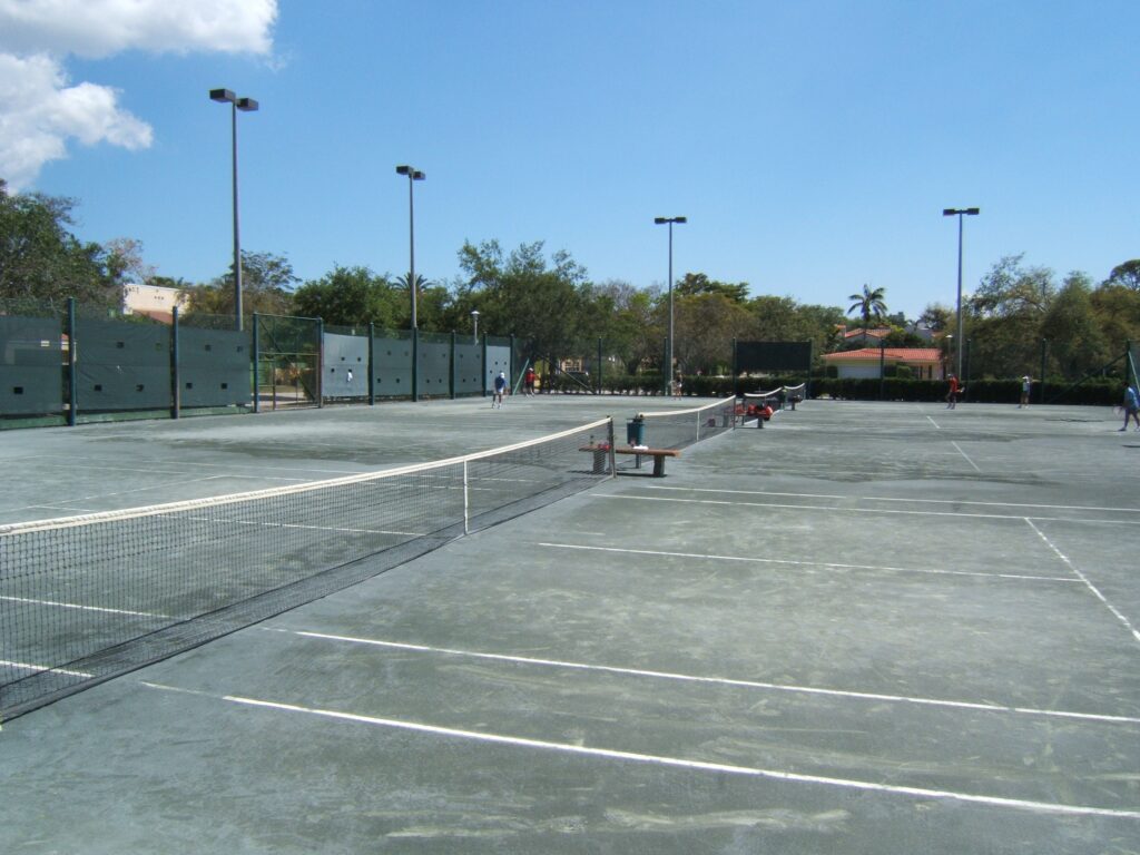 Salvador Park Tennis Center in Coral Gables, Florida, with surrounding palm trees and open skies